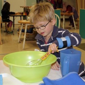  Montessori Teachers - Child Whisking into a green Bowl