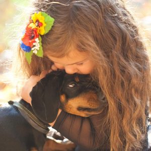 Montessori Families - A child hugging a dog