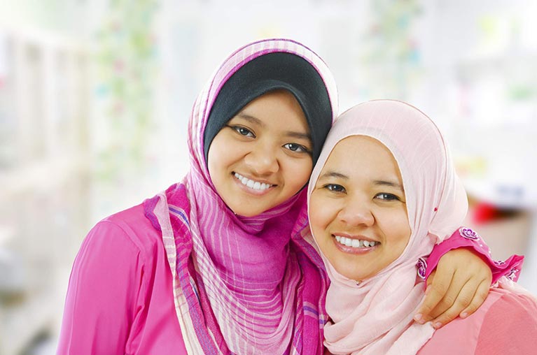 International Pages - Two Women in Hijabs Smiling